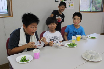 肉を頬張る小学生男子